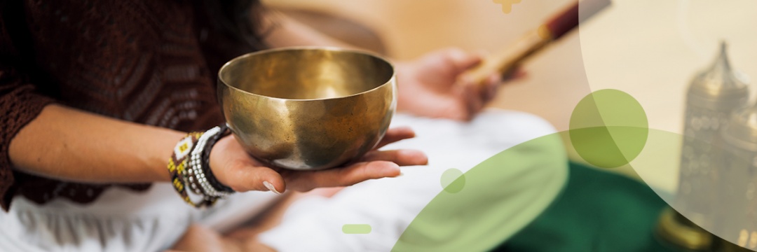 Person meditating with a singing bowl