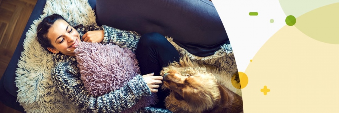 Women relaxing on sofa with dog