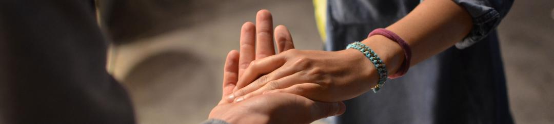 Two people holding hands