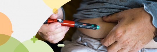 Close up of a person injecting insulin with a pen