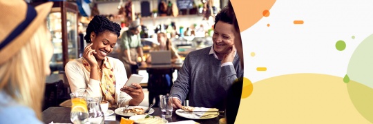 young people having a meal together and laughing