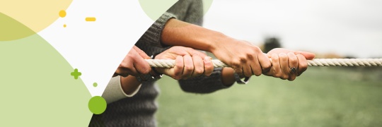 close up of hands pulling on a rope