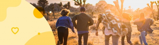 A group of people with diabetes running towards a sunset