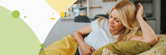 Woman holding her belly in pain, having period cramps